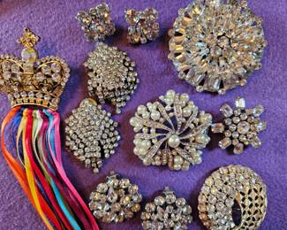 Selection of rhinestone jewelry including Weiss earrings and a large Weiss brooch.