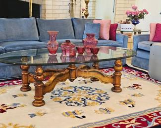 Very long 4 cushion blue velvet sofa and matching loveseat and oval glass top coffee table.