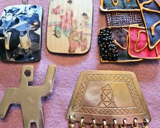 A collection of diverse brooches and pendants from China and from various artisans