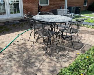 Vintage cast round patio table &4 chairs. Very heavy.