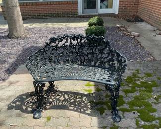 Cast bench with grapes.
