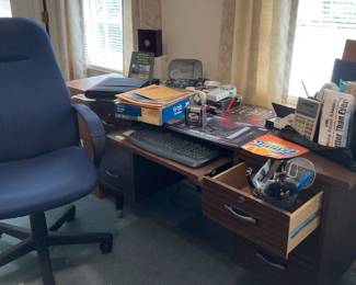 Desk And Chair With Lots Of Office Supplies 