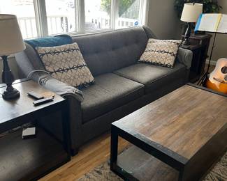 Couch , coffee table with matching end tables , area rugs , lamps 