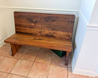 Solid wood bench in front entry. 