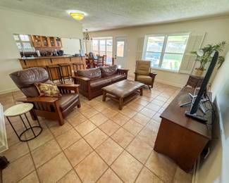 Living room set of Leopold Stickley furniture. Entertainment center, sleeper sofa, recliner and rocking chair. Plus pottery barn coffee table with soft leather top. 