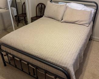 Metal frame bed in upstairs bedroom. 