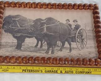 large tramp art frame w picture of a wagon driven by team of buffalo