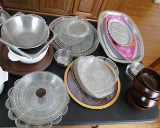 Wooden bowls, meatal serving platters, and glass items for baking and serving too