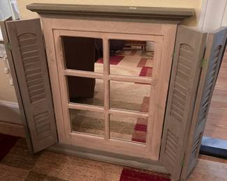 wall mirror with closeable shutters