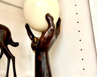 Carved hand holding ostrich egg