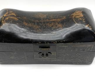 LOT 162 Register: www.woodardlipe.com CHINESE LEATHER PILLOW BOX, QING DYNASTY, C. 1880 Height 6 in, length 11.5, depth 5.5 in. Chainese leather pillow box with pressed hammer work of floral design, symbolizes good fortune and prosperity. Often used for storage of important documents or opium objects during traveling. Qing Dynasty, Guangxu Period. Certificate of Guaranty included.