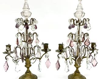 LOT 103 Register: www.woodardlipe.com PAIR OF DROP CRYSTAL FRENCH GIRANDOLES, C. 1900 Length 10.5 in, width 5.5 in, height 18 in. Brass two arm girandoles with clear and amethyst drop crystals. The girandole is a branched candelabra that resembles a chandelier. These are not electrified.