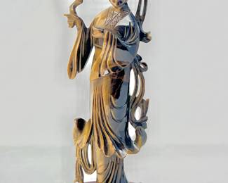 LOT 71 Register: www.woodardlipe.com HAND CARVED TIGER EYE KWAN YIN FIGURINE HOLDING A FLOWER ON ROSEWOOD STAND Height 9 in., width 3.5 in., depth 1.5 in., Total weight with stand, 665 grams. Hand carved intricately detailed Kwan Yin with lower poised in a long robe upon a carved Rosewood stand.