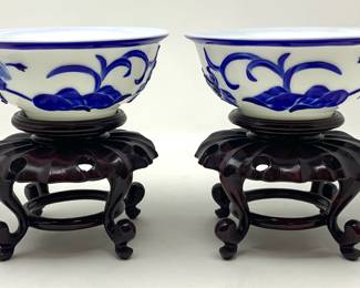 LOT 69 Register: www.woodardlipe.com PAIR CHINESE PEKING GLASS BLUE AND WHITE CAMEO BOWL ON STAND Diameter 6 in, height 2.75 in. Bright cobalt blue iris and vine motif on white glass bowl. Two wood stands accompany the bowls. Peking Glass is a traditional form of art that starts with a one-color glass base, dipped into contrasting colored glass one layer at a time.