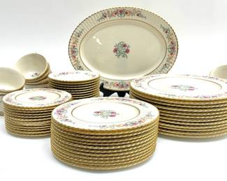 LOT 126 Register: www.woodardlipe.com 63 PIECE SET OF LENOX "CINDERELLA" CHINA, PATTERN V-308 WITH GOLD TRIM Includes 12 dinner plates, 12 salad plates, 12 bread plates, 14 tea cups and 12 saucers, and an oval platter, these porcelain floral design china with fluted edges were manufactured from 1947-1966.
