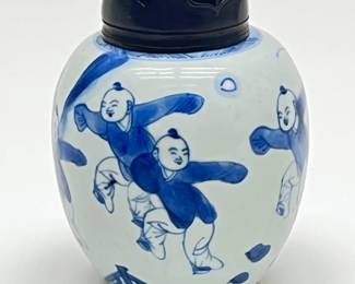 LOT 96 Register: www.woodardlipe.com CHINESE BLUE AND WHITE JAR KANGXI PERIOD Height 5 in., diameter 3.75. Blue and White children at play on porcelain with carved wooden lid. Kangxi Period.