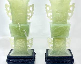 LOT 34 Register: www.woodardlipe.com SERPENTINE CARVED MOTTLED CELADON JADE FISH AND LOTUS DESIGN VASE PAIR Height 8 in, width 3.75 in, depth 2 in, height with base 9.5 in. Caved translucent green vase with prominent carp and lotus flower surface design relief.
