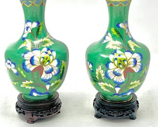 LOT 62 Register: www.woodardlipe.com PAIR, GREEN CLOISONNE VASES WITH PEONY MOTIF AND BRASS INTERIOR ON WOOD STANDS Diameter 4 in, height 8 in. with stand. Mid-century cloisonné vases with large dark blue and white peony, branches and leaves with brass interior of vase. Vases are attached to carved wood bases.