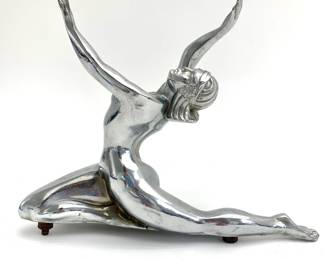 LOT 88 Register: www.woodardlipe.com C. 1930 VINTAGE ART DECO CAR HOOD ORNAMENT Length 10 in, depth 1.75 in, height 8 in. This nude woman goddess hood ornament collector's item c. 1930 has been removed from its base, but displays the elegance and fluid movements that were popular choices for hood ornaments in the 1920s and 1930s.