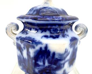 LOT 95 Register: www.woodardlipe.com ANTIQUE FLOW BLUE CHINA SUGAR CANISTER WITH LID, BY CHARLES MEIGH, "TROY" PATTERN, C. 1840-1849 Length 7 in, width 5 in, height 7.75 in. Flow blue is intentionally a bit blurred, an effect that results from adding lime to the kiln as the piece was being fired.The CM Marking indicates that this piece was made between 1840 - 1849. Early Victorian Flow Blue (1830-1860) was ironstone, in intense cobalt with designs which usually cover the entire piece. These designs closely mimicked the Oriental patterns imported from Canton and Nanking. Stamped on the bottom Troy, CM