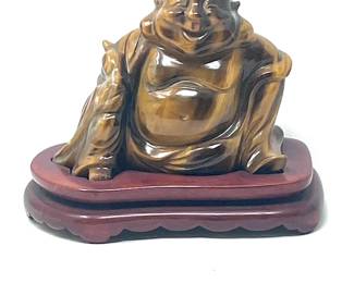 LOT 36 Register: www.woodardlipe.com CARVED TIGER EYE HOTEI BUDDHA Width 4.5 in., height 3.75, depth 1.5 in., mineral weight 470 grams, The Hotei Buddha is one of the shichi fukujin, or Seven Lucky Gods, in Japanese Shintoism. Hotei is a god of good luck and good fortune and may be called the Laughing Buddha. He is also known as the cloth sack monk or Budai in China.