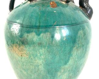 LOT 101 Register: www.woodardlipe.com CERAMIC CHINESE WINE JUG WITH ROPE, C. 1900, HUNAN PROVINCE, CHINA Diameter 10 in, height 12.5 in. Traditionally used for storing rice wine, this large ceramic turquoise glazed jug with crackling and age around the neck. It features a handle, opening and spout with four small rings around the opening. The candle wax export imprint is visible on the exterior.