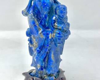 LOT 46 Register: www.woodardlipe.com LAPIS MAN AND CHILD ON WOODEN BASE Height 5 in., width 2 in., depth 2 in., Mineral weight, 308 grams, Lapis Lazuli brings calmness and aids in expressing emotions. It is used to ward off psychic attacks. It is a powerful stone that helps you find inner peace, intuition and wisdom. Lapis Lazuli provides serenity and tranquility that makes the wearer self-dependent and concentrated on truth and trust.