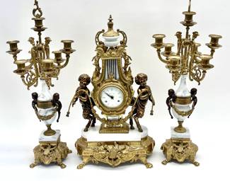 LOT 158 Register: www.woodardlipe.com 3 PIECE IMPERIAL BREVETTATO HERMLE ITALIAN BRASS AND MARBLE MANTLE CLOCK AND CANDELABRA GARNITURE SET CLOCK Height 24 in., width 15 in., depth 8.5 in, GARNITURE each, height 27 in., diameter 12 in., oversized and dramatic brass and marble mantle clock by Imperial. Made in Italy. Neoclassical design with garland, ribbon, rooster and cherub accents.