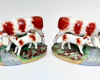 LOT 161 Register: www.woodardlipe.com OLD STAFFORDSHIRE WARE ENGLAND IRONSTONE HEIFER AND CALF, PAIR, 19TH CENTURY Height 4.25 in., width 6 in., depth 3.5 in.; Glazed ironstone figurines in complementary chiral pair. Condition, very good with no shipping or damage to the body apparent or scratches to the surface.