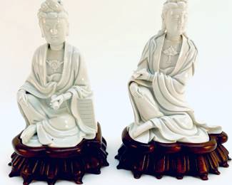 LOT 82 Register: www.woodardlipe.com PAIR BUDDHAS BLANC DE CHINE ON CARVED LOTUS LEAF WOODEN BASE Height 8 in., Base width 7 in, each. White Porcelain Buddhas sit atop hand carved rosewood bases.