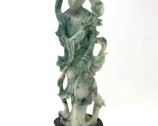 LOT 78 Register: www.woodardlipe.com CARVED MOSS JADE KWAN YIN FIGURE WITH FAN AND FLOWER Height 7.25 in., width 2.75 in., depth 1.75 in., Total weight 383 grams.