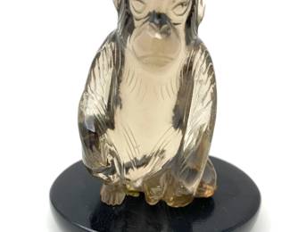 LOT 32 Register: www.woodardlipe.com SMOKY QUARTZ MONKEY, 19TH CENTURY/EARLY 20TH CENTURY Length 2.5 in, width 2.25 in, height 3.25 in. with stand. Weight 108 gram with stand. Vintage monkey carved of smokey crystal sits on rosewood base.