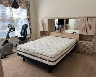 Bedroom Set #1 – Includes a queen-size adjustable Serta Motion iSeries bed (Beautyrest mattress), armoire, headboard with side cabinets, mirror, & TV stand.