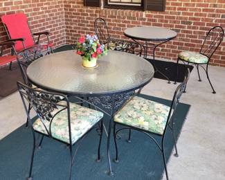 Very nice iron tables and chairs .