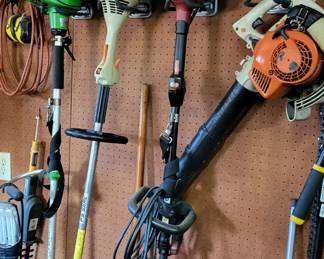 Selection of saws and weed eaters.