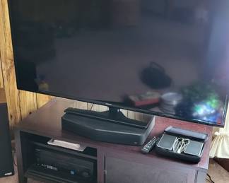 Newer TV and stereo set in nice modern TV stand.