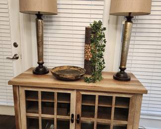 two door console with two tall lamps