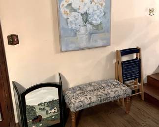 Here, of course, you can see a couple of wooden folding chairs, a cushioned bench, and a small tri-fold screen.  But don't forget the painting on the wall.