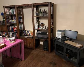 Here you can see a nice display shelving unit, and lots of figurines, books, and other media.