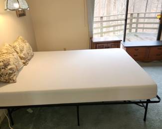 Spotless Queen mattress on folding metal frame. Made in 2023