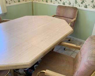 #64	octangle table with laminate top and 1 leaf and 4 rolling chairs 42-60x42x29	 $50.00