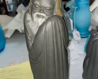 One of a pair of unusual Asian figures