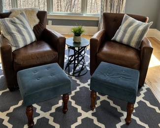 Leather club chairs and stools. The rug is not for sale