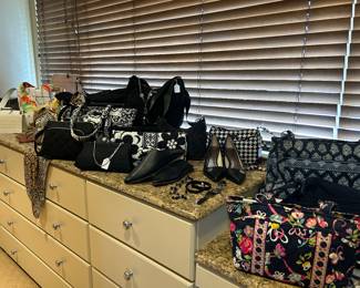 LARGE MASTER CLOSET WITH WOMEN'S AND MEN'S CLOTHING.