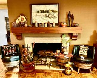 fireplace with art, game barrel chairs and table.