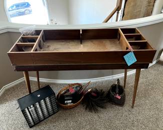 Vintage wooden game table with stand for spinning top and pins for bowling game.