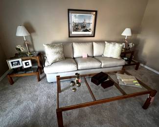 Leather sleeper sofa and living room furnishings. A glass top coffee table with matching end table set.