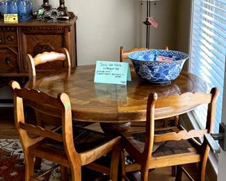 Solid Oak Table with Parquet Top, includes leaves and 4 chairs. Additional chairs available.