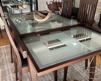 Glass dining table with hidden glass leaves