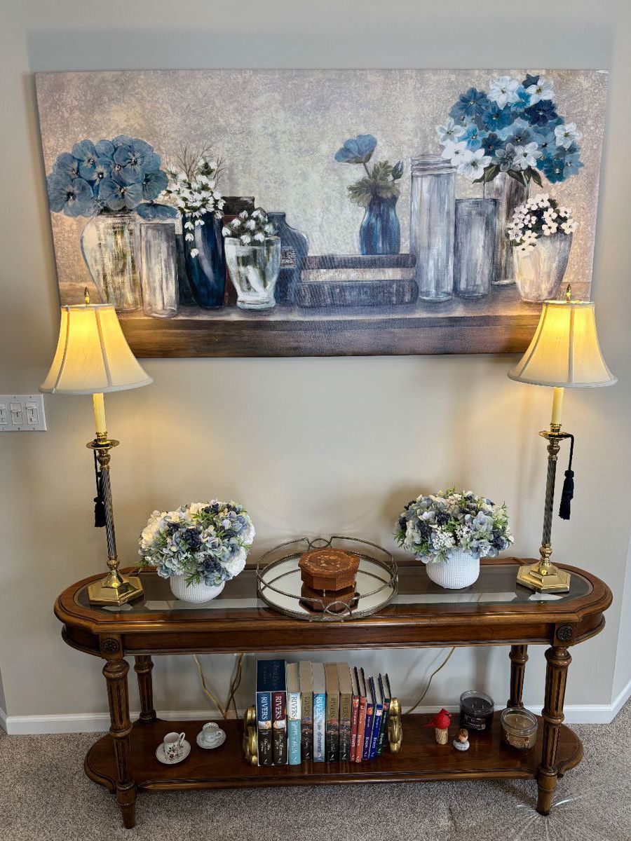 Beautiful accent table, brass lamps, books, artwork